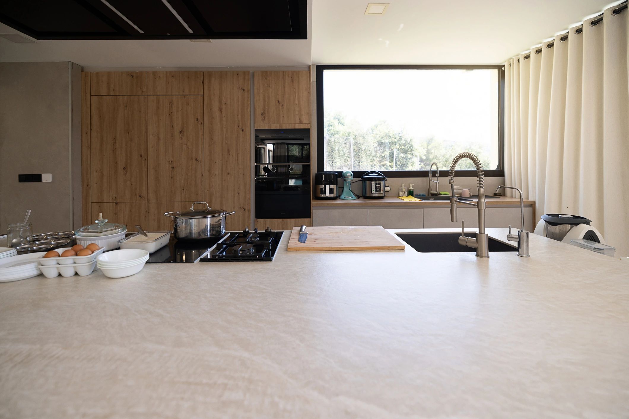Modern kitchen counter with stove and wooden cabinets